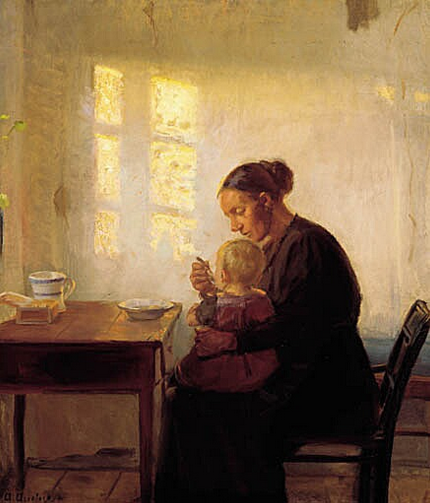 A mother with her child in a sunlit room.